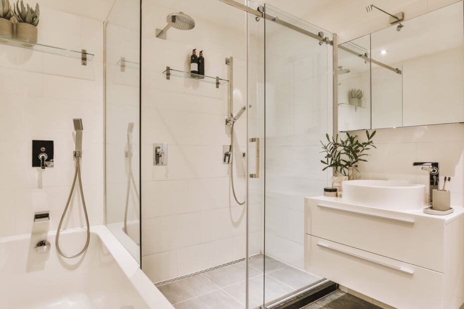 Interior of an elegant bathroom with newly installed glass shower doors.
